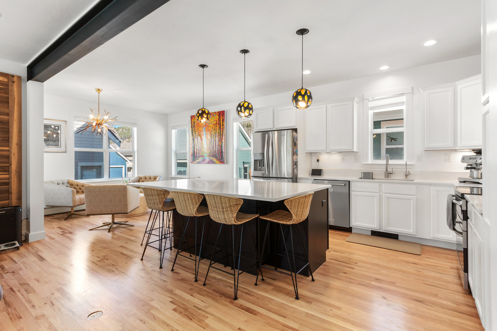 Image of a kitchen and living area with statement lighting